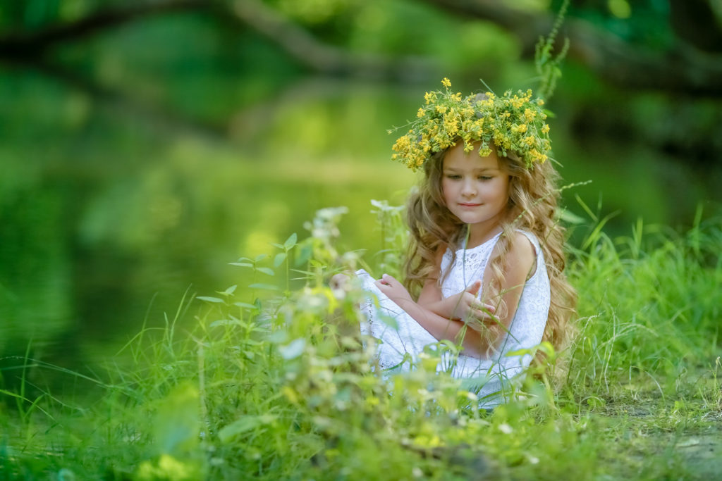 Homeopathy creates balance between sience, tradition and intuition. Girl sitting in grass.